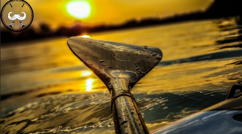 SUP sunset paddle fading sun light glimmering on the water