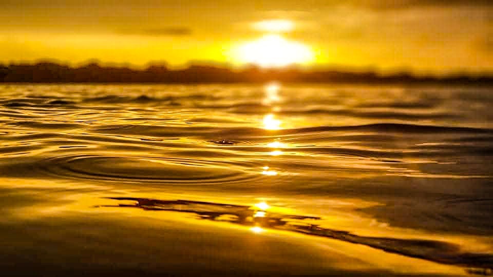 Sun Set paddleboard session sun setting on the water
